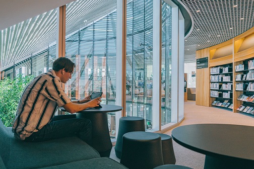 Man on computer in library