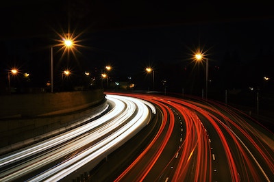 photo of cars going fast in highway